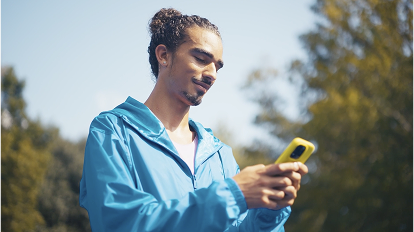 Person in blue jacket using smartphone while walking outdoors on sunny day, shown in multiple connected photos
